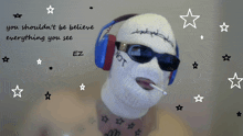 a man wearing a ski mask and headphones has a tattoo on his chest that says hot