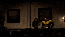 a bald man is sitting in a chair in front of a group of superheros .