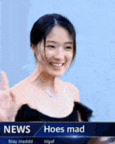 a woman in a black dress is smiling in front of a news headline that says hoes mad
