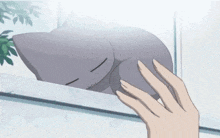 a hand is touching a cartoon character with a large smile