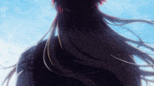 a woman with long hair and a tattoo on her arm looks up at the sky