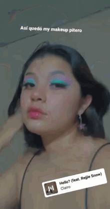 a close up of a woman 's face with pink and green eye shadow