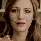 a close up of a woman 's face with tears running down her face