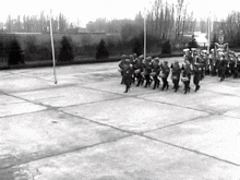 a black and white photo of a marching band playing instruments