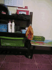 a shelf with bottles and baskets and a calendar on the wall