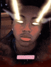 a man with glowing eyes and the name bbbbatman on the bottom right