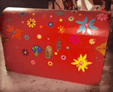 a red trunk with flowers and mushrooms on it