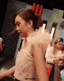 a woman in a white dress with mayward written on her shoulder