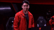 a man in a red jacket with a mercedes logo on the chest
