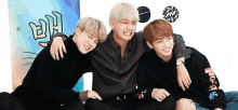 three boys are sitting next to each other on a couch .