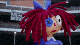 a stuffed doll with red hair and a blue bow has a button in her eye