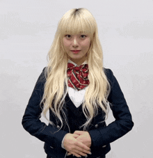 a girl with blonde hair wearing a school uniform