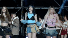 a group of girls are dancing on stage and one of them is wearing a shirt that says lakers
