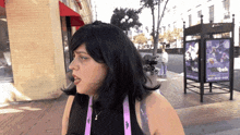 a woman with a lanyard around her neck that says twitch on it