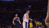 a basketball player with the number 17 on his jersey is pointing