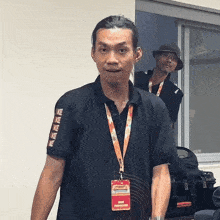 a man wearing a black shirt with the word ke on the sleeves