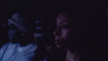 a woman is crying in a dark room