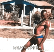 a man in a bathing suit is walking down a street and says what 's up ?