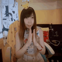 a girl with a pikachu on her head is wearing a cartoon shirt