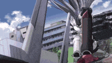 a robot is standing in front of a building in a city with a blue sky in the background .