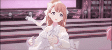 a girl in a white dress is standing on a stage in front of a pink background .