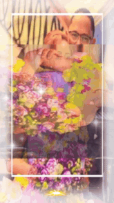 a man with glasses is surrounded by flowers