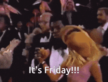 a man in a tuxedo is carrying a woman in a dress and the words it 's friday !!! are visible