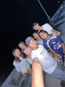 a group of young people posing for a picture with one wearing a shirt that says ' malice archives ' on it