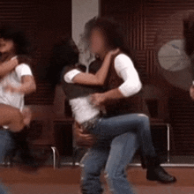 a man is carrying a woman in his arms and they are dancing