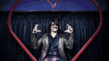 a man in a leopard print jacket is sitting in front of a heart