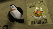 a penguin is standing next to a package that says 6957 on it