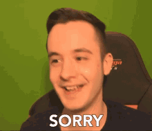 a man sitting in a gaming chair says sorry