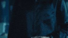 a close up of a person 's torso in the dark