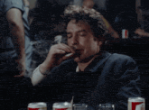 a man is smoking a cigarette in a dark room