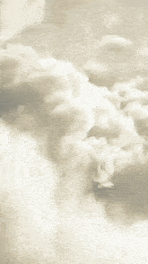 a person standing in front of a cloudy sky with their feet up