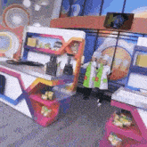 two chefs are standing in front of a colorful kitchen .