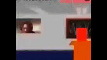 a blurry picture of a person looking out a window with a red object in the foreground .
