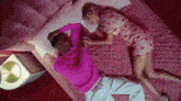 a man and a woman are laying on a bed together .