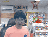 a man in front of a hug me sign