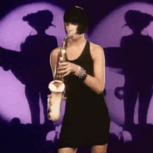 a woman in a black dress is playing a saxophone in front of purple lights