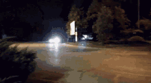 a car is driving down the road at night