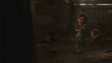a person is holding a gun in a dark room in a dark room .