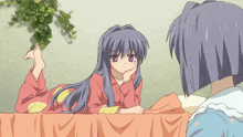 a girl with long hair is laying on a bed with her hand on her chin