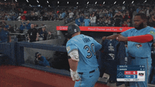 a man in a blue jays jersey stands in front of a crowd