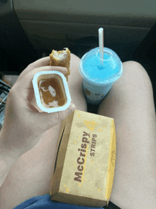 a person is eating mcdonald 's mccrispy strips