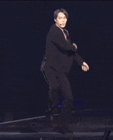 a man without a shirt is dancing on stage