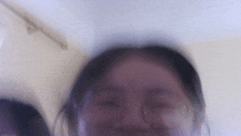 a blurry picture of a woman 's face with glasses and a date stamp of 2020