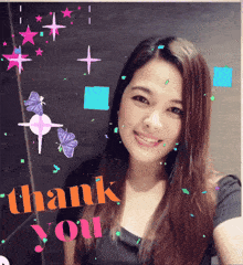 a woman is smiling in front of a sign that says " thank you "
