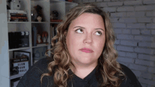 a woman in front of a shelf with a sign that says mom boss