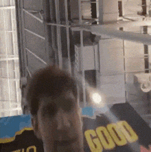 a person is standing in front of a sign that says good on it